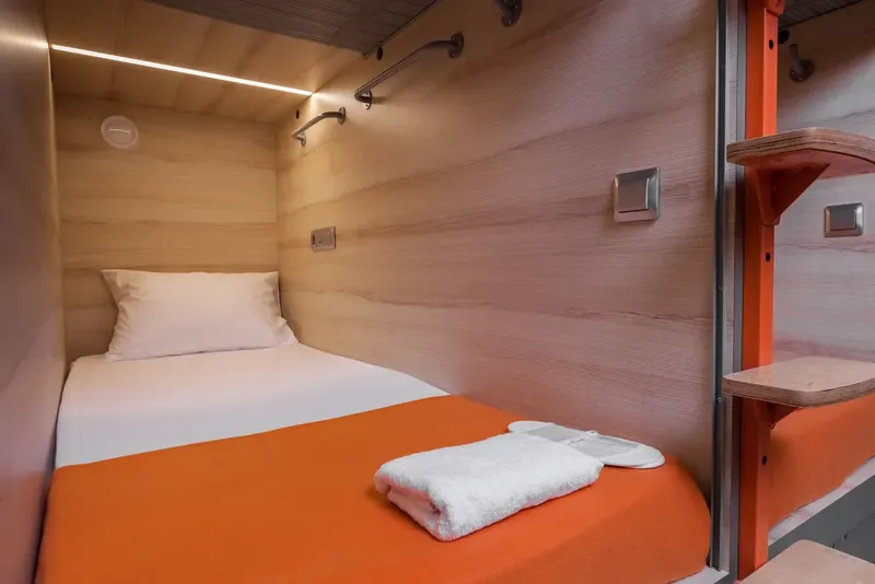 Single lower capsule pod interior LED strip lighting wooden walls GettSleep Aeroexpress