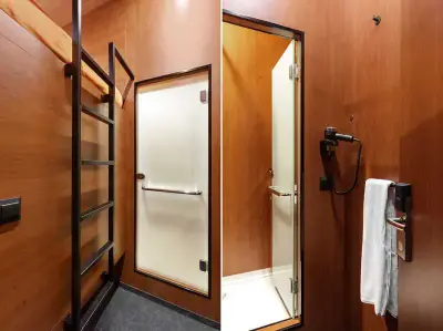 Vista interior minihabitación superior Yin-Yang GettSleep cama ropa blanca iluminación LED cálida Terminal C