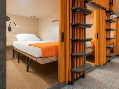 Cápsula Comfort inferior cortina naranja abierta GettSleep Terminal B salidas