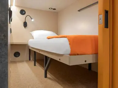 Vista angular cama cápsula Comfort superior GettSleep Terminal B salidas