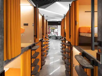 Corredor cápsulas dos niveles vista lounge GettSleep Terminal B salidas